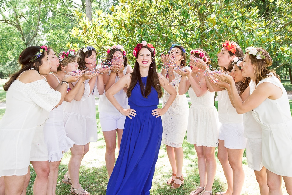 les filles lancent des confettis à la mariée pour une photo EVJF